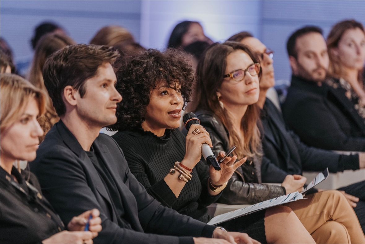 A member of the jury speaking into a microphone