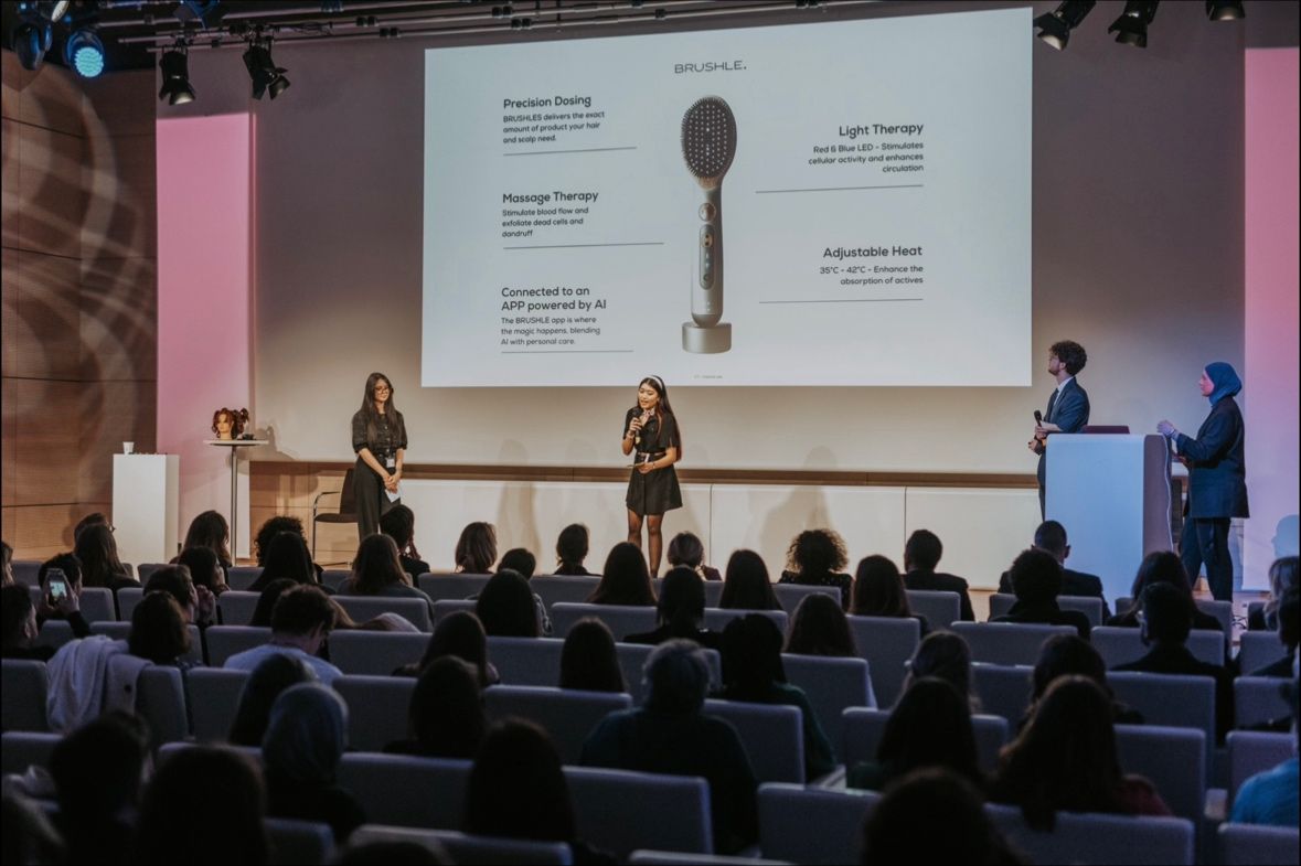 The team presenting the Brushle smart hairbrush concept on stage